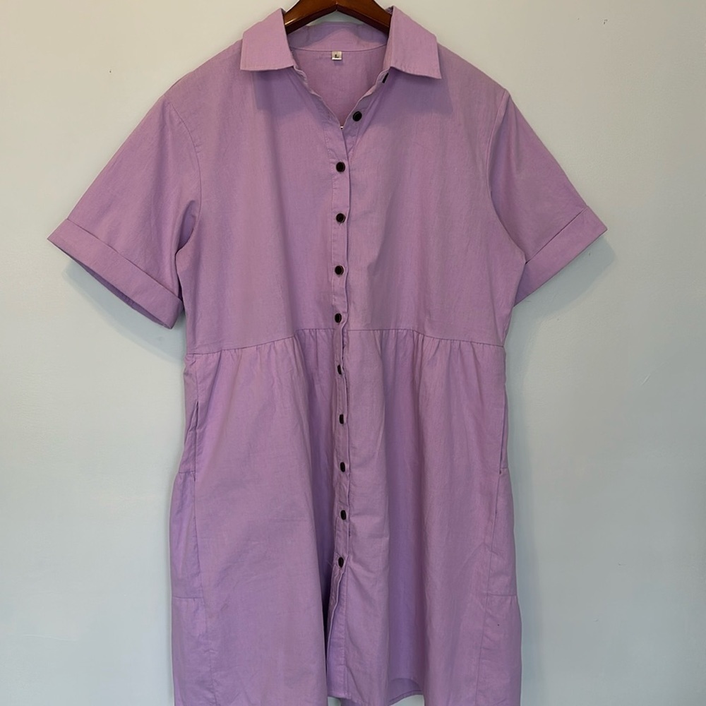 Adorable cotton dress. Purple short sleeves with pockets and ruffled back detail
